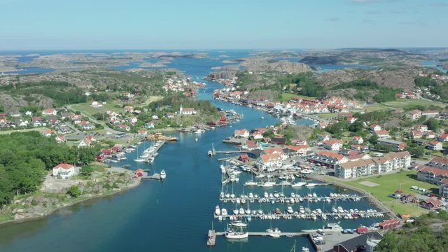 Sweden west coast village from above. Small coastal town with boats and harbour aerial drone shot. Swedish summer at the ocean. Archipelago island landscape view. Bohus Gothenburg. Houses small hotel