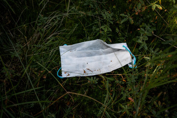 Closeup shot of a sanitary mask on grass