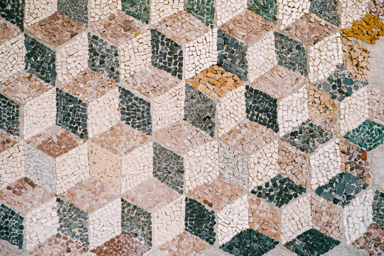 Beautiful ancient Roman style mosaic pattern in background. Ceramic mosaic in the form of volumetric cubes.