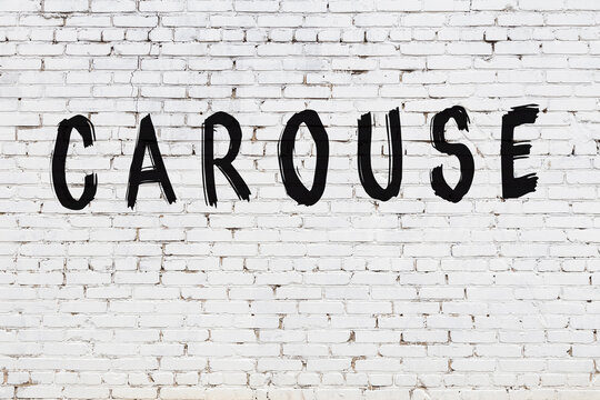 White wall with black paint inscription carouse on it