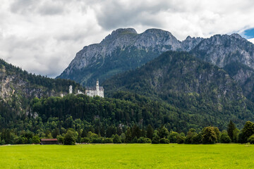 Fototapeta na wymiar Beautiful view to the castle Neuschanstein in Füssen, Bavaria, Germany at a cloudy day in summer.