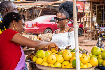 young african lady shopping for food stuff in a local market