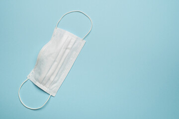 Obraz premium Surgical protective face mask white on blue background