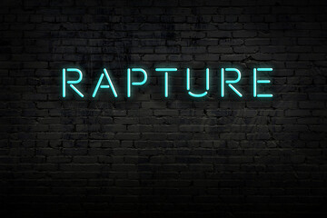 Night view of neon sign on brick wall with inscription rapture