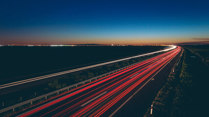 Beautiful view of transportation lights on the road at night time © Milan Šurbatović/Wirestock
