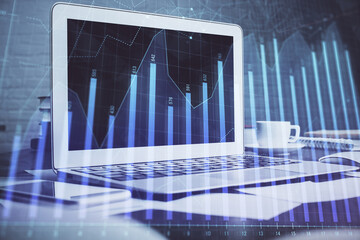 Stock market graph on background with desk and personal computer. Double exposure. Concept of financial analysis.