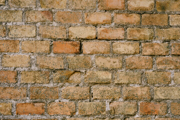 Texture closeup of an old brown brick wall.