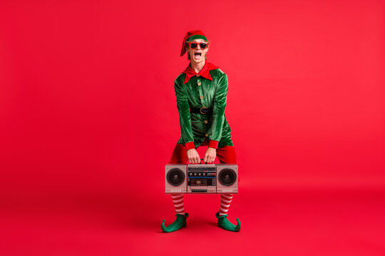 Full body photo of crazy elf hold boom box on x-mas christmas party wear costume isolated over bright color background