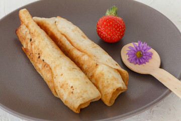 Homemade pancakes filled with cottage cheese on a plate