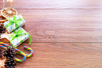 Christmas accessories, gifts, candy, oranges, top view. New year or Christmas background with space for text