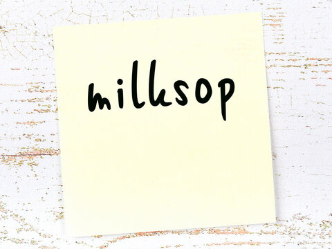 Yellow Sticky Note On Wooden Wall With Handwritten Word Milksop