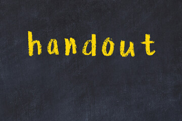 College chalk desk with the word handout written on in