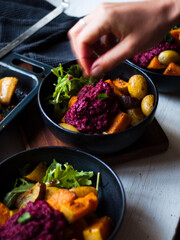 Home made roast vegetables with arugula and beetroot puree. Natural light.