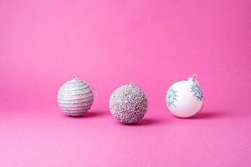 Christmas New Year composition. Gifts, silver and white ball decorations on pink background. Winter holidays concept. Angle view