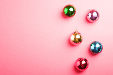 Christmas New Year composition. Gifts, colorful ball decorations on pink background. Winter holidays concept. Flat lay, top view, copy space