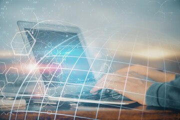 Multi exposure of world map hologram with man working on computer on background. Concept of...