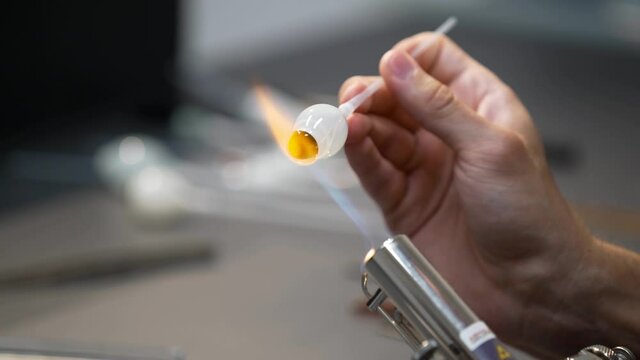 Glass eye prosthetic production (Ocular prosthesis). Burning Glass on a burner. 4K Video