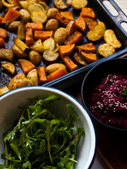 Home made roast vegetables with arugula and beetroot puree. Natural light.