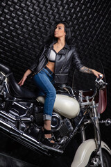 Fototapeta na wymiar Nice woman sitting on a motorcycle