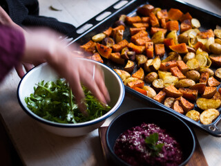 Home made roast vegetables with arugula and beetroot puree. Natural light.