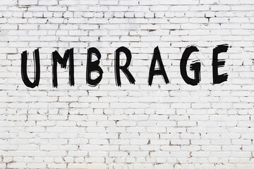 Inscription umbrage painted on white brick wall