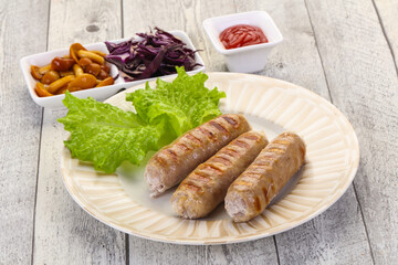 Grilled sausages served mushrooms and cabbage