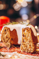 Christmas stollen: holiday pie decorated with rosemary and Christmas decor on the table. Сoncept for postcard, banner, holiday greeting