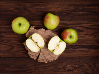 Apples on a dark wooden table.