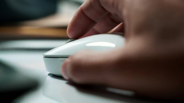 Click white computer mouse on a work desk. Working with a PC or laptop. Close-up Footage of the workplace in 4K