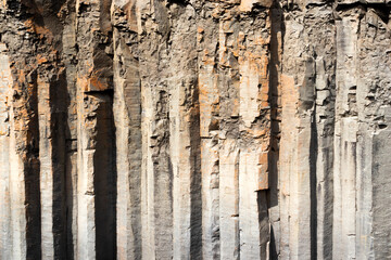 The wall of basalt columns in Studlagil canyon in Jokuldalur Valley in Iceland. Texture of a volcanic basalt rock.