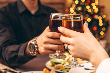 romantic atmosphere of celebration of the New Year and Christmas. Photo of holiday table, loving couple celebrating holiday at home