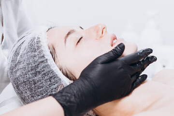 portrait of client in spa. Woman with true natural beauty, young brunette on a regular cosmetic procedure with her doctor