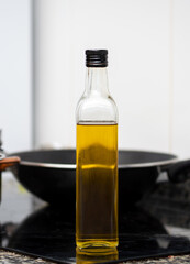Glass bottle of cooking oil on kitchen counter