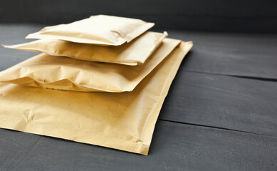 Four different size of paper envelopes on the wooden table
