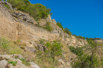 Fototapeta na wymiar the remains of a medieval fortress city (according to other sources - a monastery) Tepe-Kermen, covering the upper part of the mountain in several tiers