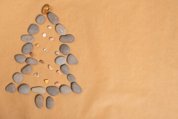 Summer New Year concept. Christmas tree made of smooth sea stone.
