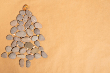 Summer New Year concept. Christmas tree made of smooth sea stone.