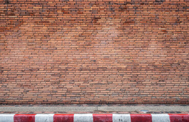 red brick wall texture grunge background With footpaths that prohibit parking