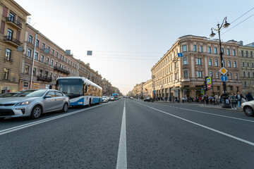 Nevsky prospect with cars and people on a sunny autumn evening in Saint Petersburg, Russia.