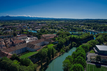 Fototapeta na wymiar Panoramic aerial view of Lake Garda, the city of Peschiera del Garda. Aerial view at high altitude. Aerial photography with drone. Coast of the largest in Italy Garda lake.