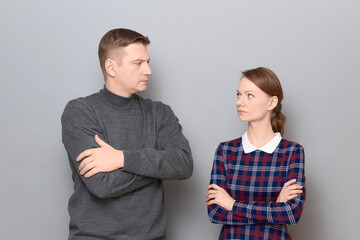 Portrait of serious man and woman looking at each other