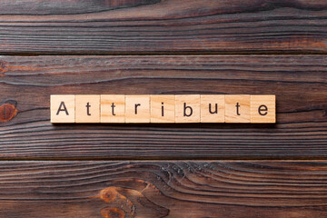 ATTRIBUTE word written on wood block. ATTRIBUTE text on cement table for your desing, concept