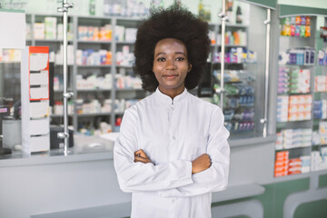 Pharmacy, healthcare concept. Young pretty smiling African dark skinned woman pharmacist in white...