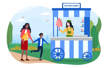 Mom and daughter buying cotton candy from a street vendor at a fair.