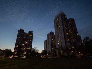 Fototapeta na wymiar Traditionnal communist housing in the suburb of Belgrade, in New Belgrade, during a dark evening. These kind of high rises are symbols of the brutalist architecture in Serbia