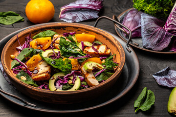Fresh salad with chicken breast, fresh tomatoes, cabbage, spinach and avocado. Food recipe background. Close up