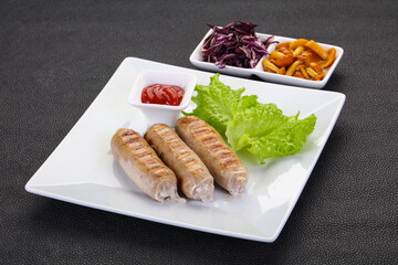 Grilled sausages served mushrooms and cabbage