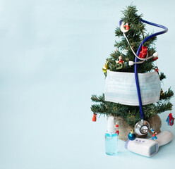 Christmas tree decorated with stethoscope and blue face masks. Covid and happy new year concept....