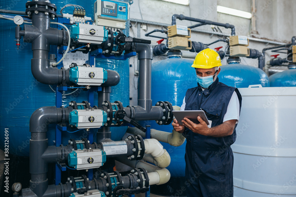 Wall mural industry worker checking chemical water treatment equipment