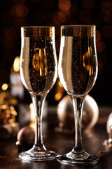 selective focus of glasses full of champagne against christmas lights